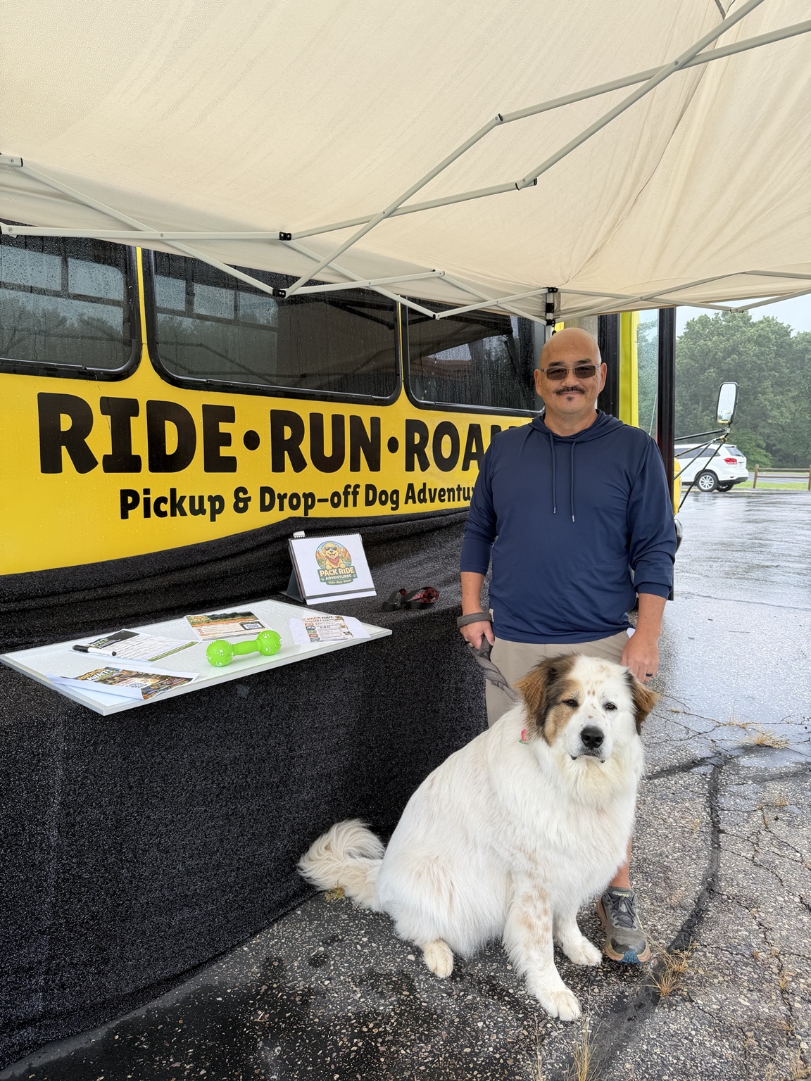 Guest and dog visiting the Pack Ride bus information table